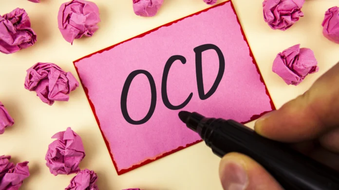A pink sticky noted with OCD written on it, short for Obsessive-compulsive disorder