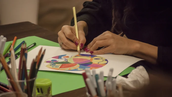 A person participates in art therapy by making art