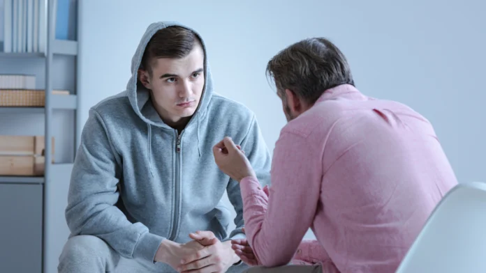 A man speaks with a therapist in an individual therapy session