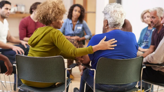 People participate in a drug addiction support group
