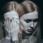 A woman covering her face with her hands after encountering one of her phobias or depression