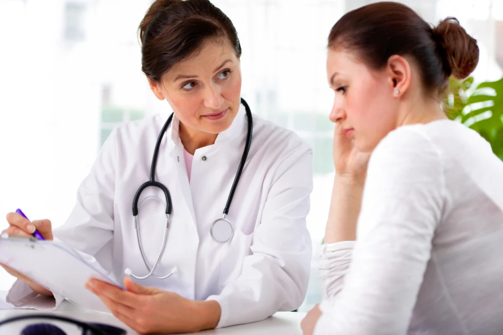 A doctor speaks with a patient during a consultation