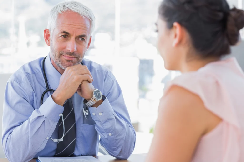 A doctor speaks with a patient during an appointment