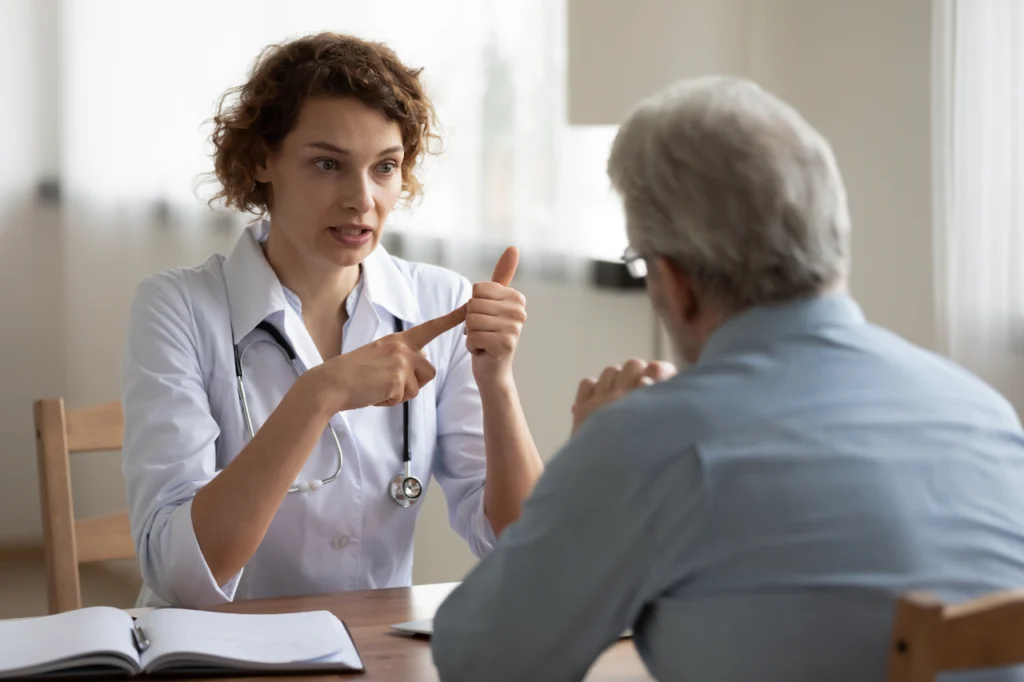 A doctor explains something to a patient during a consultation