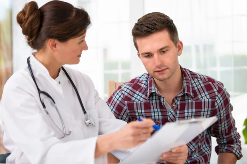 A doctor speaks with a patient during a consultation