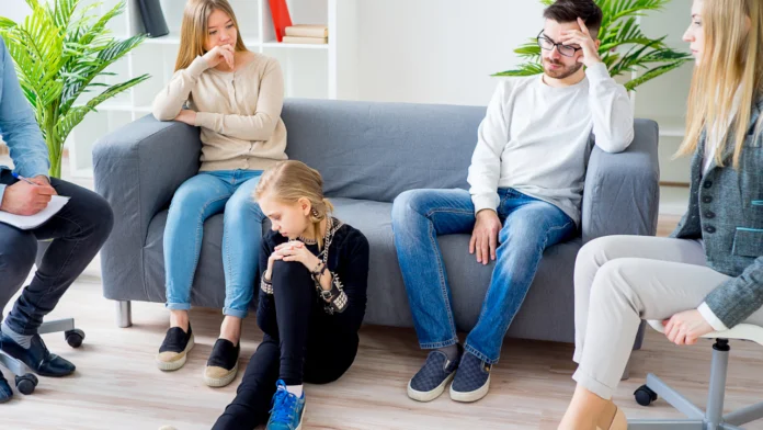 A frustrated family sits in a therapy session
