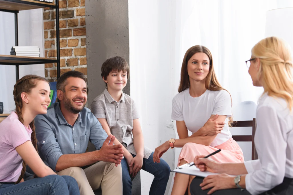 A family partakes in a session of family systems therapy at a therapist's office