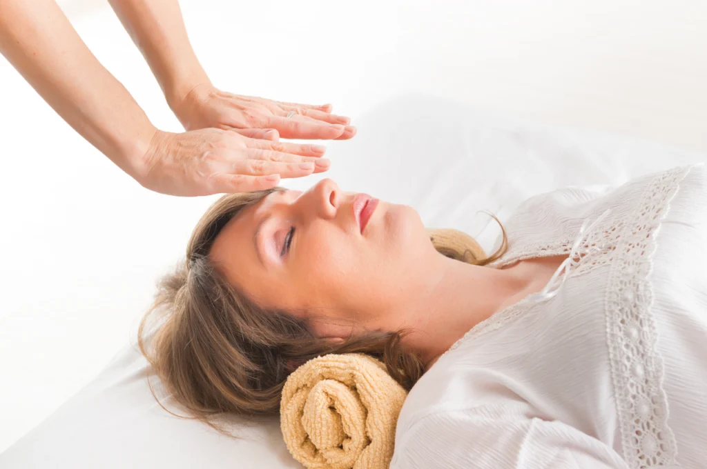 A woman receives holistic, hands-free meditative healing