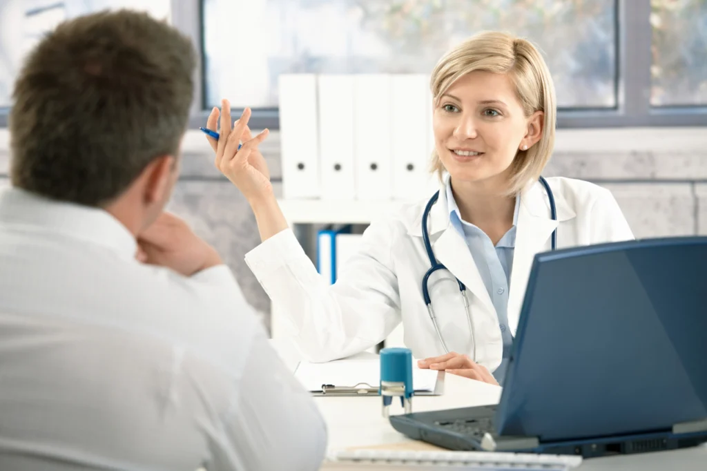 A doctor speaks with a patient during an appointment