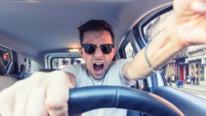 A man deals with anger issues while behind the wheel. Anger therapy can help with moments like this.