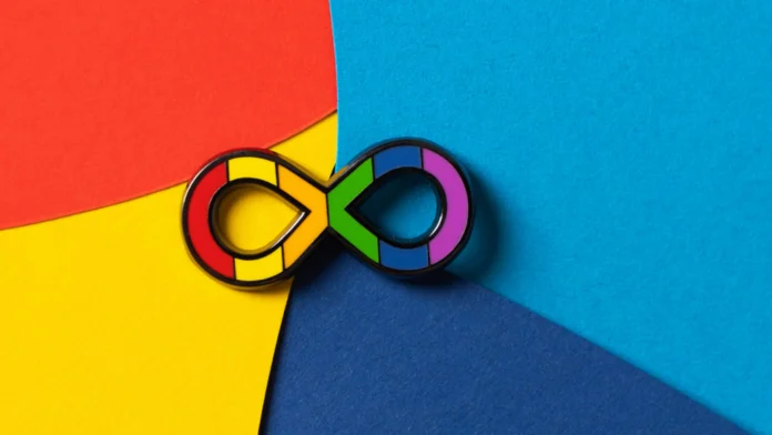 A rainbow infinity symbol, representing autism. Therapy for autism can help adults cope with the difficulties of living with autism.