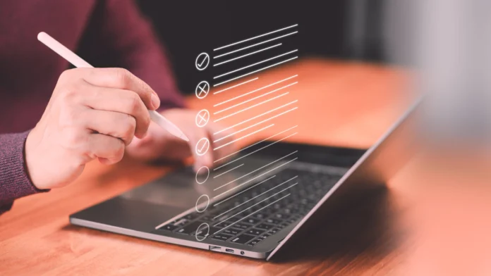 A person takes an online quiz on their laptop. Learn more about the benefits and efficacy of taking an eating disorder quiz online, here.