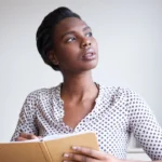 A woman writing in a journal. Read more affirmations and helpful eating disorder quotes here.