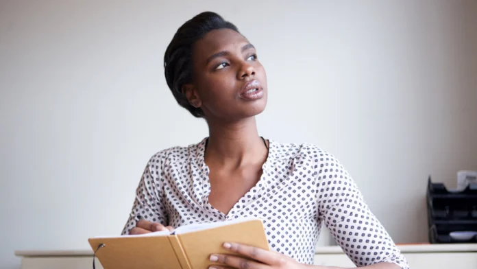 A woman writing in a journal. Read more affirmations and helpful eating disorder quotes here.