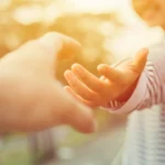 A person reaches out to offer a helping hand. Learn more about how to help someone with an eating disorder here.