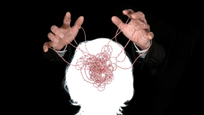 A graphic of two hands manipulating a person's mind. Learn more about gaslighting, including signs, examples, and how to get help, here.