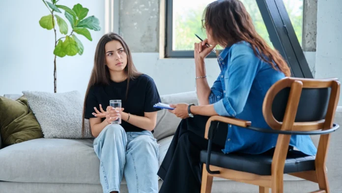 A woman speaks with a therapist. Learn more about sexual abuse, signs, effects, and support options here