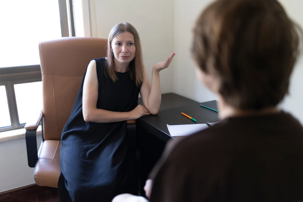 A doctor and a patient speak during an appointment