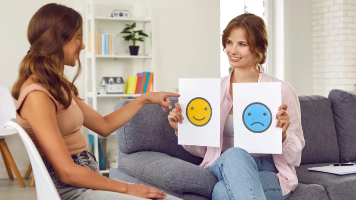 A person selects between a happy and frowny face with a therapist. If you'd ever wondered, "do I need a therapy", you questions are answered, here.